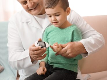 Doctor,Measuring,Patient's,Blood,Sugar,Level,With,Digital,Glucose,Meter