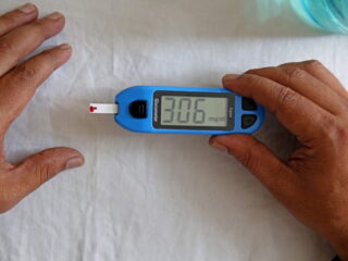 epa09581249 A health official checks the sugar level reading of a person during free diabetes awareness camp on the occasion of 'World Diabetes Day' in Bangalore, India, 14 November 2021. The walk was aimed to create awareness about diabetes and free access to diabetes care and prevention. 14 November is observed as World Diabetes Day.  EPA/JAGADEESH NV